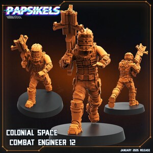 May include: Three 3D printed miniature figures of space-suited soldiers, each holding a weapon. The figures are painted in a muted orange colour and are standing on black bases. The text "COLONIAL SPACE COMBAT ENGINEER 12" is printed below the figures.