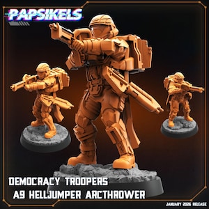 Op de afbeelding: Oranje miniatuurfiguren van Democracy Troopers, A9 Helljumper Arcthrowers, in een futuristisch gevechtspak, met een wapen. De figuren staan op een grijze basis. De tekst "Papsikels" staat bovenaan. De tekst "January 2026 Release" staat onderaan.