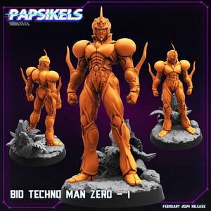 May include: A 3D printed figurine of a humanoid robot in a yellow and orange colour scheme. The robot has a sharp, pointed head and a muscular build. The figurine is posed in a dynamic stance, with one arm raised and the other lowered. The figurine is standing on a base with a textured surface. The text "BIO TECHNO MAN ZERO - 1" is printed on the base.