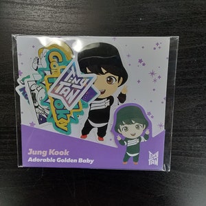 May include: A set of stickers featuring a cartoon character with the text "Tiny Tan" and "Jung Kook Adorable Golden Baby". The stickers are on a white background with purple accents.