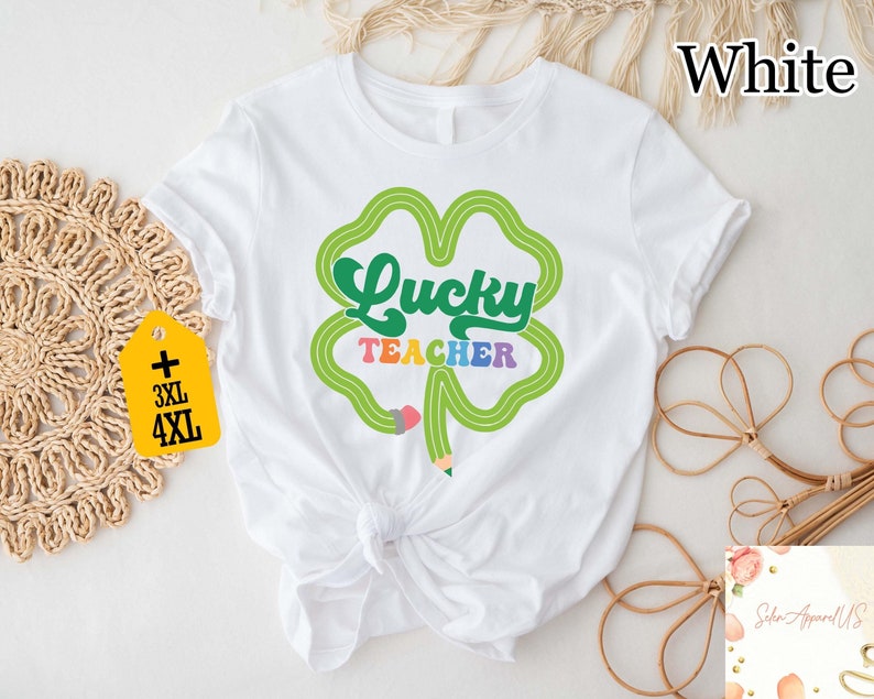 a white t - shirt with a shamrock saying lucky teacher