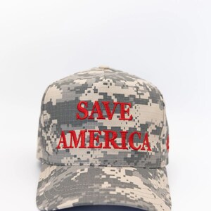 May include: A camouflage baseball cap with the words "SAVE AMERICA" embroidered in red.