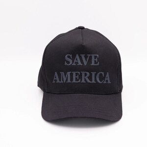 May include: A black baseball cap with the text "SAVE AMERICA" embroidered in grey on the front.