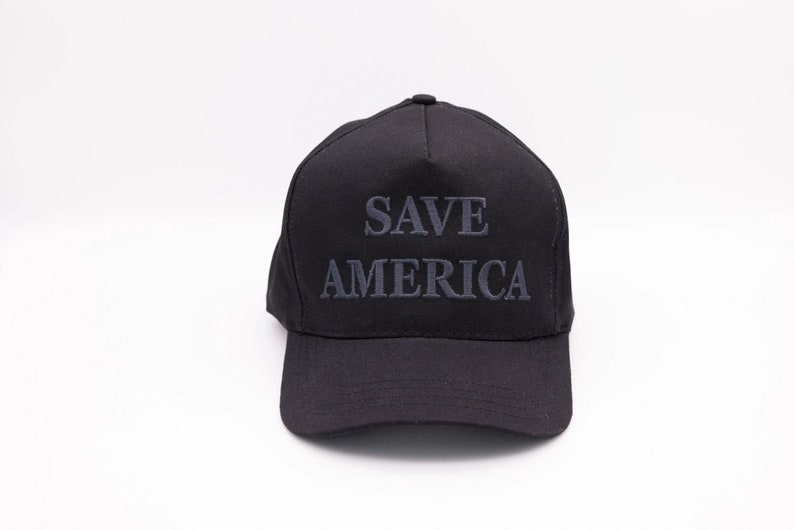 May include: A black baseball cap with the text "SAVE AMERICA" embroidered in grey on the front.