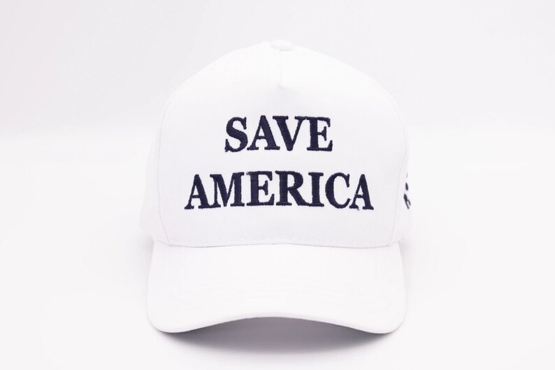May include: White baseball cap with the text "SAVE AMERICA" embroidered in black.