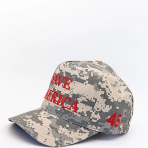 May include: A camouflage baseball cap with the words "Save America" and the number "45" embroidered in red.