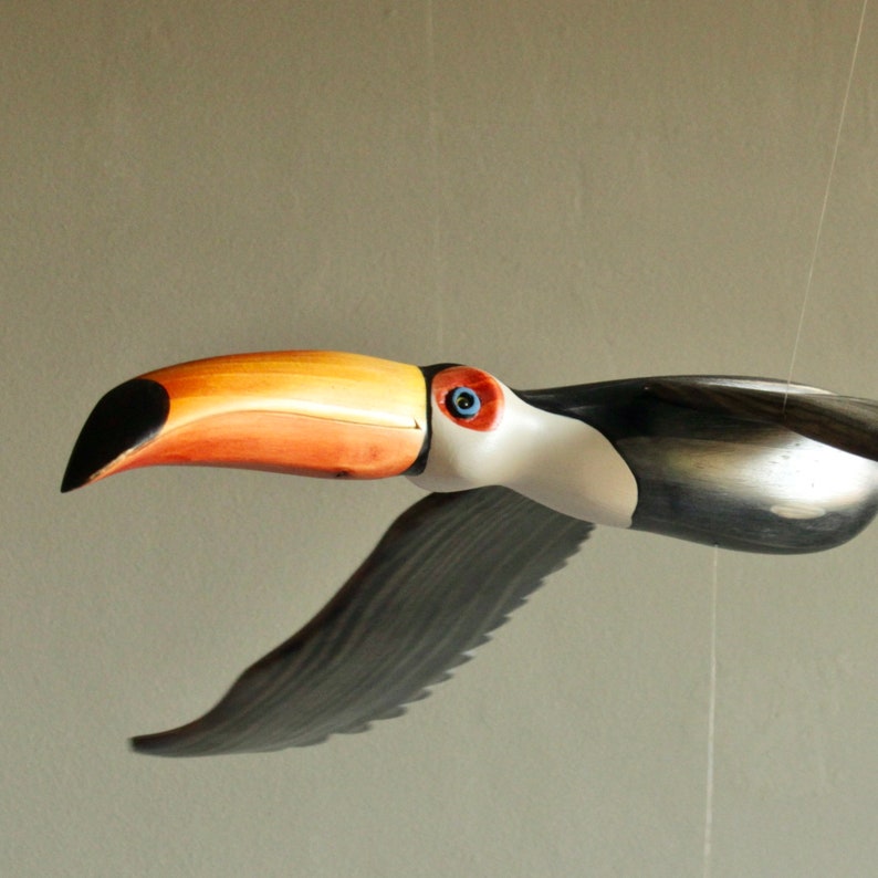 Beautifuly carved and painted Toucan Mobile bird in Flight. This image shows a close up