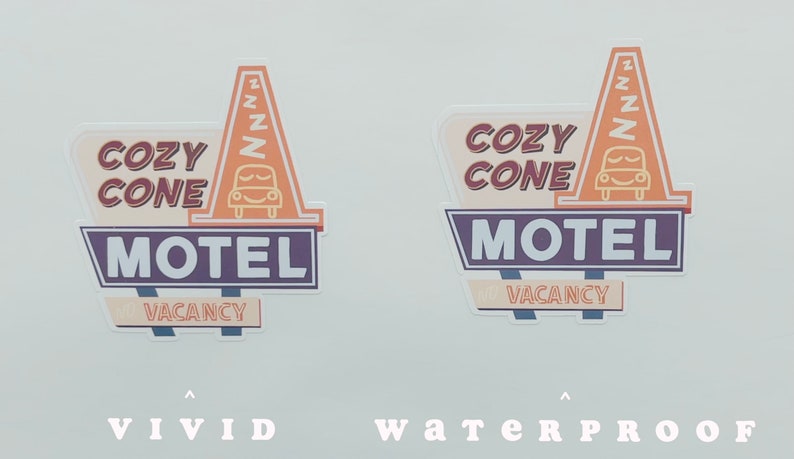 May include: Two vintage-style motel signs with the text "Cozy Cone Motel" in a retro font. The signs are orange, brown, and purple with a white "Vacancy" sign at the bottom. The signs are on a white background.