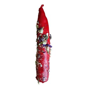 May include: A vibrant red candle with a pointed top, decorated with dried flowers and herbs. The candle features white, purple, and green botanical elements. The background is plain white.