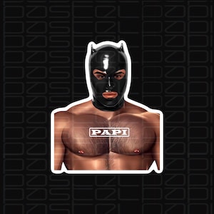 May include: A black latex mask with ear-like protrusions and the word "PAPI" printed on the chest of a person wearing the mask.