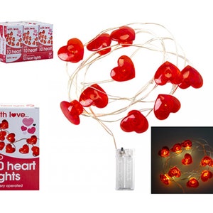 May include: A string of 10 battery-operated LED lights shaped like red hearts. The lights are on a clear wire and come in a box that says "LED 10 heart lights battery operated".