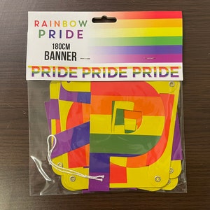 May include: Rainbow Pride banner with the word "PRIDE" repeated three times. The banner is made of colourful paper and is 180 cm long.