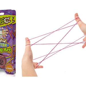 May include: A package of pink and purple glitter string art. The package shows a hand holding the string art, creating a design. The package says "Magical Glitter String Art" and "Classic Fun!"