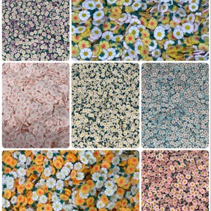 May include: Assortment of colourful flower-shaped polymer clay charms. The charms are in various colours, including pink, white, yellow, and blue. The charms are perfect for adding a touch of whimsy to crafts and jewellery.