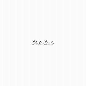 May include: The image features the text "Shakti Studio" in elegant cursive script. The text is in black and is centered on a white background with subtle vertical stripes, creating a clean and minimalist aesthetic.