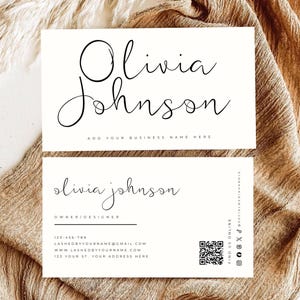 May include: Two white rectangular business cards with black text. The top card displays the name Olivia Johnson and the text Add Your Business Name Here. The bottom card includes the name, title Owner/Designer, contact details, and a QR code.