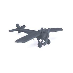 May include: A grey toy aeroplane with a propeller and wheels. The aeroplane is made of plastic and has a simple design.