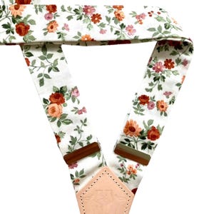 Floral linen suspenders with back detail and leather accents, perfect for vintage, festival, and boho styling.