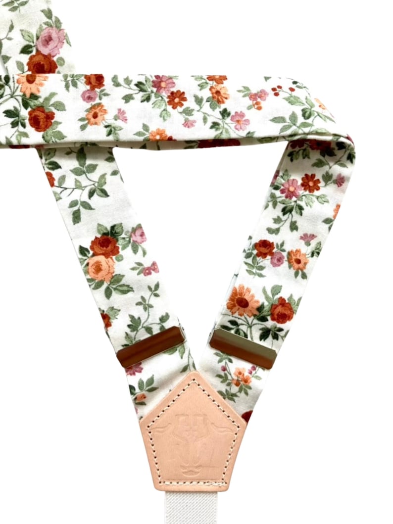 Floral linen suspenders with back detail and leather accents, perfect for vintage, festival, and boho styling.