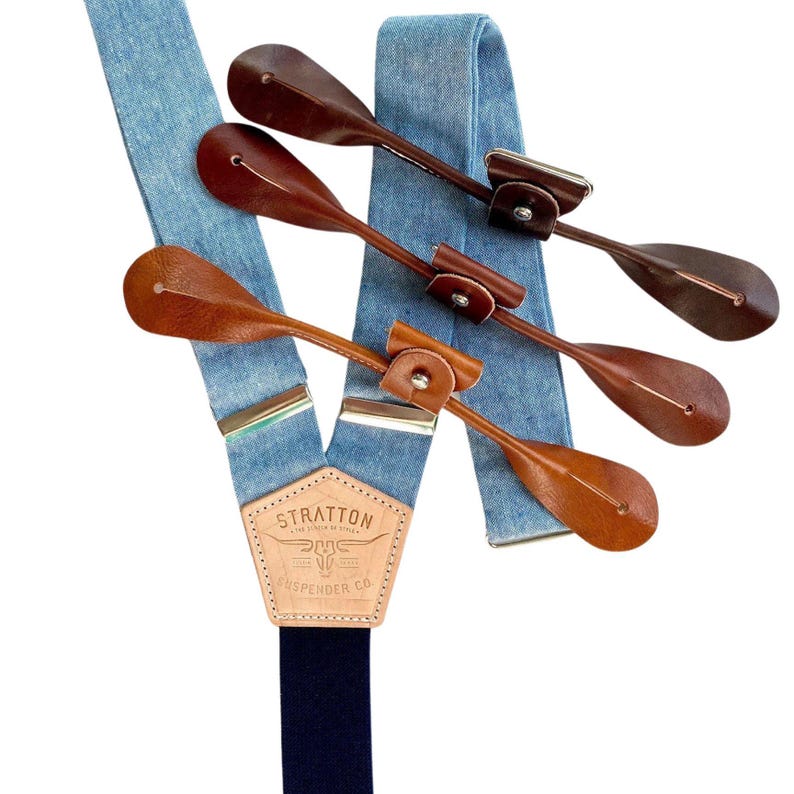 Light blue linen button suspenders with a navy elastic back strap and vegetable-tanned leather ends. Handmade by Stratton Suspender Co. Perfect for weddings, groomsmen, and classic menswear. Ethically crafted for premium quality and timeless style.