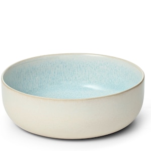 Könnte beinhalten: Eine große, hellblaue und cremefarbene Servierschüssel aus Keramik. Die Schüssel hat eine gesprenkelte Glasur und eine abgerundete Form.