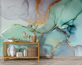 May include: A wooden console table with two shelves, featuring a white ceramic vase with a decorative pattern, a small wooden horse figurine, a woven basket, and a stack of books. The table is set against a wall with an abstract green, blue, and gold marble-like wallpaper.
