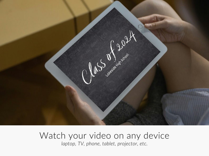 May include: A white tablet with a black screen displaying the text "Class of 2024 Lakeside High School". The text is written in white chalk on a black chalkboard background. The tablet is being held by a person's hands.