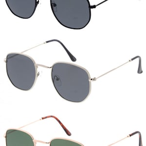 May include: Three pairs of sunglasses with a geometric shape. The top pair has black frames and dark gray lenses. The middle pair has silver frames and dark gray lenses. The bottom pair has rose gold frames and green lenses.