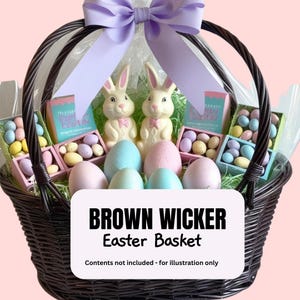 May include: A brown wicker Easter basket with a purple bow, filled with pastel-colored eggs, chocolate bunnies, and small boxes of candy. The text "Happy Easter" is visible on the boxes. Contents not included - for illustration only.