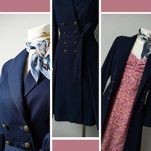 May include: A navy blue pleated coat with a double breasted closure, gold buttons, and a matching belt. The coat is shown on a mannequin with a white and blue patterned scarf.