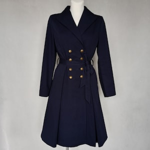 May include: A navy blue double-breasted coat with a flared skirt and gold buttons.