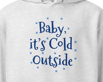 May include: A light gray heather hoodie featuring a front kangaroo pocket, a drawstring hood, and the dark blue text "Baby, it's Cold Outside" surrounded by small light blue dots printed on the center of the chest area of the garment.
