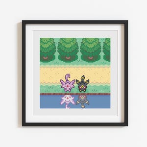 May include: Framed pixel art featuring four colorful creatures in a landscape setting. The artwork depicts a scene with trees, a path, and a body of water. The creatures are in shades of pink, black, and gray, with a pixelated aesthetic.