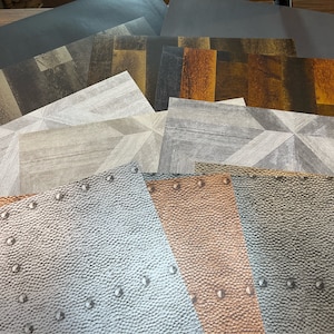 May include: A collection of 10 different patterned paper sheets. The sheets feature a variety of textures and designs, including wood grain, metal, and leather. The sheets are perfect for crafting, scrapbooking, and other creative projects.