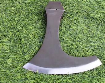 May include: A dark gray metal axe head with a wide, curved, sharpened blade edge and a narrow neck that flares out toward the top. The metal surface has a matte finish with a polished, silver-toned edge along the bottom curve of the blade.