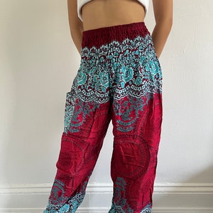 May include: Red and teal patterned pants with an elastic waistband. The pants have a loose, flowing fit and are made of a soft, comfortable fabric.