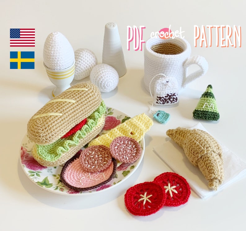 May include: Crochet amigurumi pattern for a breakfast themed set including a croissant, a sandwich, a cup of tea, eggs, and a plate of sliced salami. The pattern is available as a PDF download.