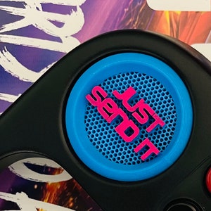 May include: A black speaker with a blue and pink button that says "Just Do It".