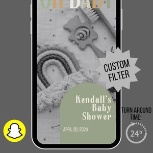 May include: A smartphone screen displaying a custom Snapchat filter for a baby shower. The filter features a rainbow, a wooden rattle, and the text "OH BABY", "Kendall's Baby Shower", "APRIL 20, 2024", "CUSTOM FILTER", and "TURN AROUND TIME: 24h".