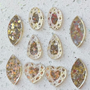 Silver cabochons, silver acrylic cabochons, silver glider cabochons.