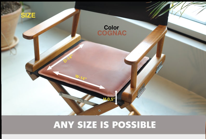 May include: A wooden director's chair with a cognac leather seat cushion. The cushion measures 14 inches wide and 14 inches deep. The chair is shown with the seat folded up. The text "ANY SIZE IS POSSIBLE" is displayed below the chair.