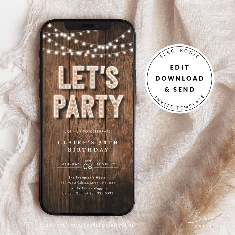 May include: A digital invitation on a smartphone screen with a rustic wood background. The text "LET'S PARTY" is in illuminated marquee letters. Details include "Claire's 30th Birthday" and event information. A string of lights hangs above the text. The invitation is an electronic template.