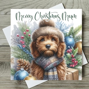 May include: A Christmas card with a watercolour illustration of a brown dog wearing a hat and scarf. The card reads "Merry Christmas Mum" and includes festive decorations like baubles, berries, and pine.