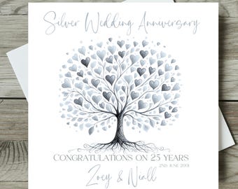 May include: A square greeting card featuring a tree with silver heart-shaped leaves. The text reads Silver Wedding Anniversary, CONGRATULATIONS ON 25 YEARS, 2ND JUNE 2001, and the names Zoey & Niall in a script font.