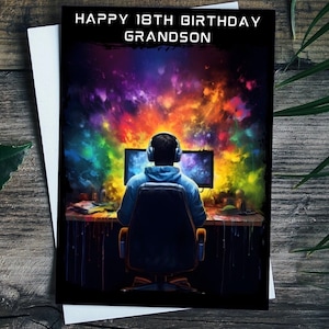May include: A birthday card with a colorful galaxy background and a person sitting in front of a computer. The card says "Happy 18th Birthday Grandson".