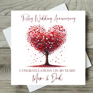 May include: A white greeting card with a heart-shaped tree composed of red hearts. The card reads "Ruby Wedding Anniversary," "Congratulations on 40 Years," and "Mum & Dad" in elegant script.