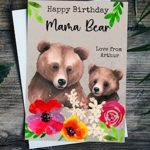 May include: A greeting card featuring a watercolour illustration of two brown bears surrounded by colourful flowers. The text on the card reads "Happy Birthday Mama Bear Love from Arthur."