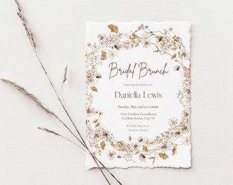 May include: A white invitation card with a floral border in shades of brown and cream. The text on the card reads "Bridal Brunch" and "Danicka Lewis".