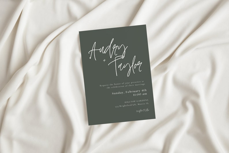 May include: A dark green wedding invitation with white calligraphy that reads "Audrey + Taylor". The invitation details the date and time of the wedding, Sunday, February 4th at 11:00 am, and the location, Hilltop Gardens, 115 Brighford LN,  Martie IL.