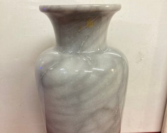May include: A gray marble vase with a smooth, polished finish. The vase has a classic, elegant design and is perfect for displaying flowers or other decorative items.